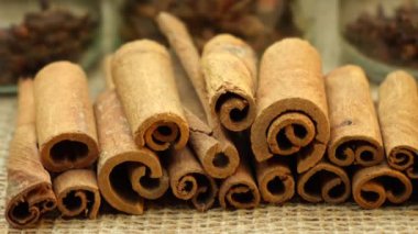 Cinnamon sticks on a surface covered with burlap. panorama close-up. High quality 4k footage