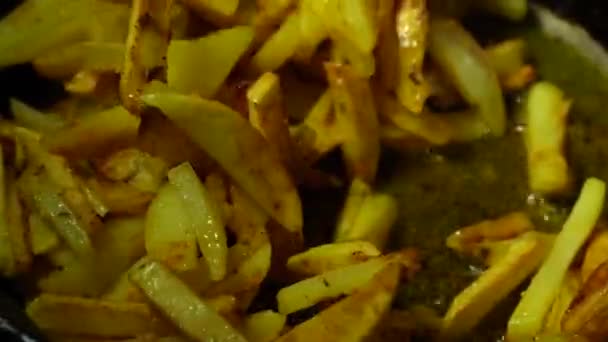 揚げジャガイモの調理プロセスのクローズアップ 1枚のジャガイモをひまわり油でフライパンで揚げ 金属製のへらで裏返します — ストック動画