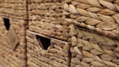 Empty rectangular wicker wooden storage baskets in a shop window. Organizer box for storage. Close-up.