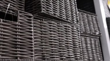 Textural wicker black wooden boxes on a store shelf. Weaving from wood, wood texture, wooden objects close-up