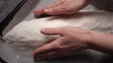 The chef forms a salt cocoon with raw fish inside before baking. The process of cooking fish in a salt shell flamb in the oven. Close up shot from above