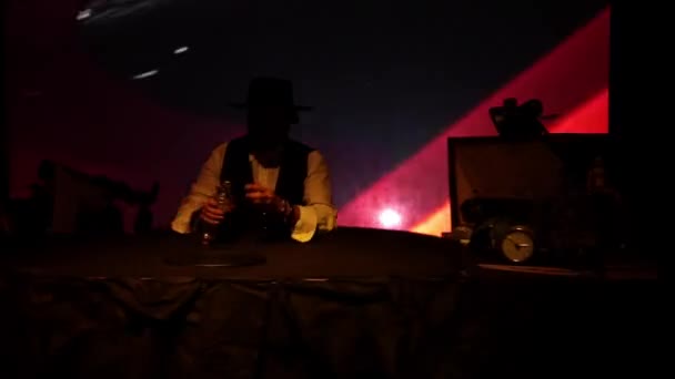 Man Hat Beard Sits Table Pours Alcohol Glass Drinks Twilight — Stock Video