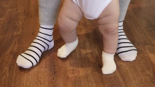 Unrecognizable Feet Baby White Socks Stomp Parquet Floor Mom Teaches — Stock Video