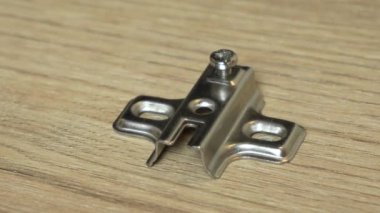 Erkek elleri dolap kapısının menteşelerini tornavidayla vidalıyor. Üst Manzara. Marangozlar iş eldivenlerini yakın plan çekiyorlar. Ağır çekim. Yüksek kaliteli FullHD görüntüler