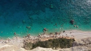 Aerial view of a Coastline with cliffs and blue water on a Greek island