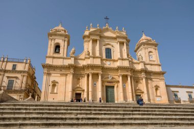 NOTO, SICILY - APRIL 23, 2019: Tourists visit the Noto cathedral and the Piazza del Duomo, Sicily 
