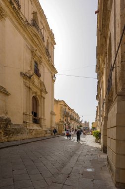 NOTO, SICILY - APRIL 23, 2019:Tourists walking in the street Vittorio Emanuele in noto, Sicily