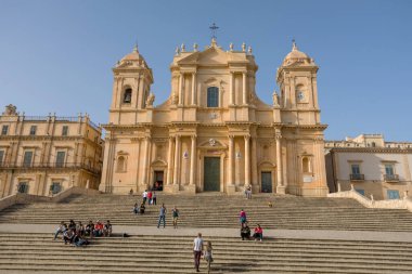 NOTO, SICILY - APRIL 23, 2019: Tourists visit the Noto cathedral and the Piazza del Duomo, Sicily 