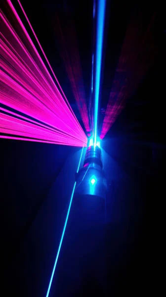 Colorful laser light glow in the dark room.