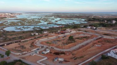 Aerial view of the construction work of the concrete foundation and infrastructures of the new residential area construction site and various heavy machinery. High quality 4k footage