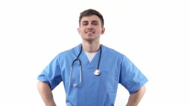 Portrait of a young medic in a blue uniform and with a stethoscope of good appearance smiles with positive emotions. On a white isolated background. High quality FullHD footage