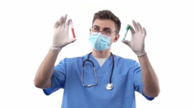 A young medic doctor chemist with a stethoscope compares two test tubes with a vaccine and a blood sample. The concept of mass vaccination. High quality FullHD footage