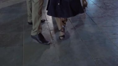 On the street in the park people dance tango. Close-up of the legs. High quality 4k footage