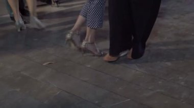 On the street in the park people dance tango. Close-up of the legs. High quality 4k footage