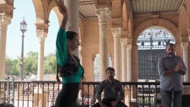 Plaza de Espana Sevilla a group of artists perform melodies and flamenco dances a girl with a bamboo fan dances. Spain Seville 2022 September 10. High quality 4k footage