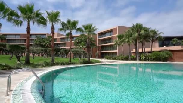 手すりと青い水のあるプール付きの美しい現代的な休日のホテル ヤシの木で芝生 そうだ 高品質4K映像 — ストック動画