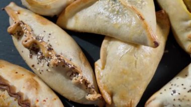 Traditional pastry empanada stuffed with various meat fillings close-up. High quality 4k footage