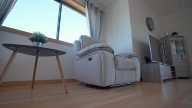 Large upholstered lounge chair in the living room with a low angle view. High quality 4k footage
