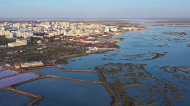 Beautiful aerial views of the Ria Formosa of the Portuguese southern town of Faro, with salt lakes and houses. Drone movement eft . High quality 4k footage