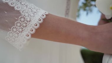 Sergide tasarım detayları ve gelinliğin danteli gösteriliyor. Yüksek kaliteli FullHD görüntüler