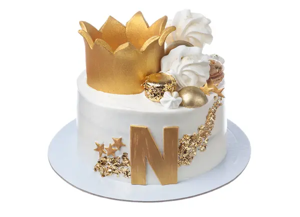 Festive white cake with the letter n in gold with marshmallows and stars. High quality photo