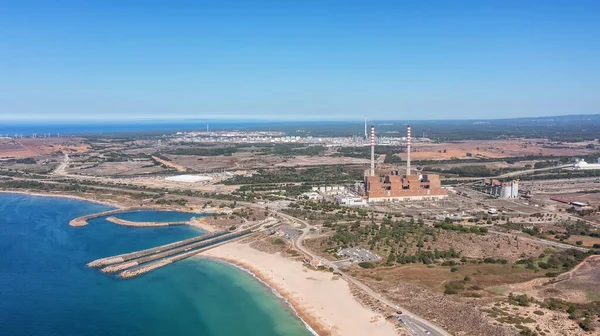 Aerial view of a coal-fired power plant in the city of Sines, overlooking the sea in Portugal. High quality 4k footage