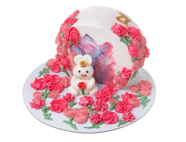 Original standing mastic cake with a bunny and rose flowers on a white isoltrovannye background. High quality photo