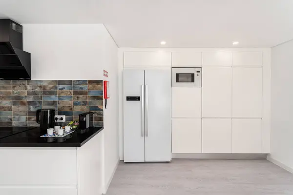 Interior background white kitchen with appliances refrigerator and counter marble counter. High quality photo