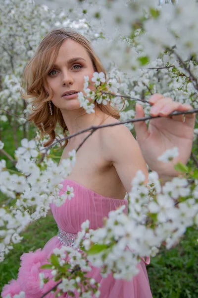 stock image Portrait of a girl in a blooming garden. Blooming trees, traditional asian, travel, seasonal april background.