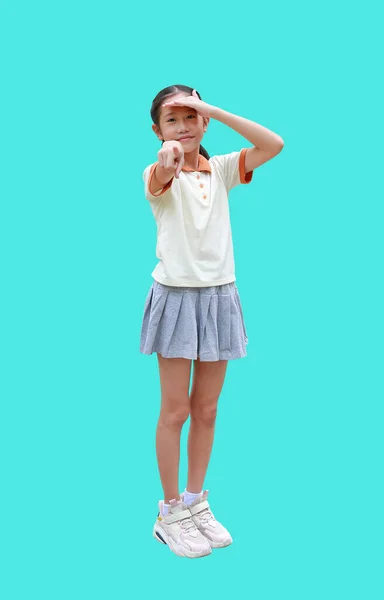 Asian young girl kid pointing index finger or forefinger straight to camera and looking gesture while standing isolated on cyan background. Image full length with Clipping path.