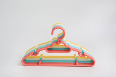 Ahşap arka planda renkli plastik elbise askıları