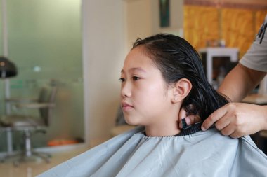 Asyalı bir kızın saçını yıkattığı portre. Kuaför kuaförü tasarımı.