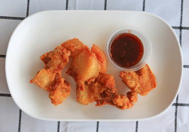 Kızarmış domuz göbeği, masada beyaz tabakta. Üst görünüm.