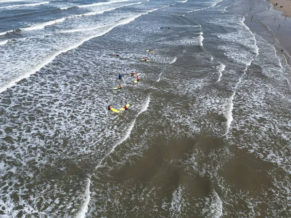 stock image Saltburn-by-the-sea surfers in the sea enjoying the waves view using a drone