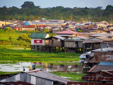 Iquitos, Peru - Apr, 2022:  Floating shantytown of Beln consisting of scores of huts, built on rafts, which rise and fall with the river. Latin America.