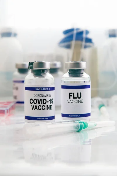 Coronavirus vaccine and Flu bottles vaccine for vaccination of new variants of Sars-cov-2 and Influenza viruses. Flu and Covid-19 vaccine vials for booster shot for covid and Influenza virus