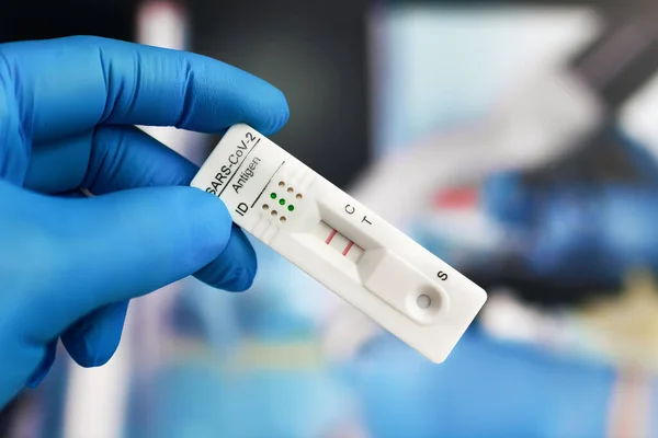 holding Coronavirus Quick test diagnostic to Sars-cov-2 or corona virus disease. doctor with Rapid test or Antigen Detection Kits (ATK) with result positive to antigens for COVID-19 or Coronavirus
