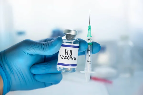 Flu vaccine for booster for Influenza virus. Doctor Holding Flu Shot vaccine for booster vaccination for Influenza virus
