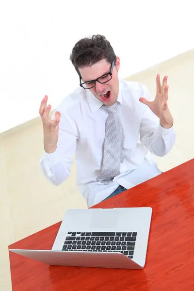 Stock image stressed out young man looking at laptop screen in despair  