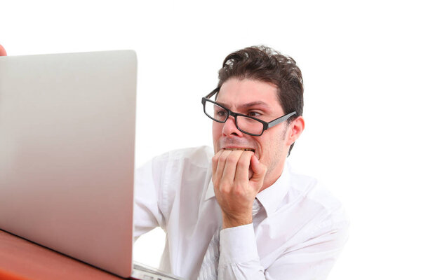 Stressed out man with glasses on white background staring at laptop screen in despair