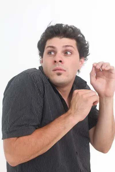 stock image scared young man on white background looking behind with fear
