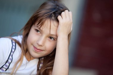 portrait of a beautiful cheerful little  girl looking sideway