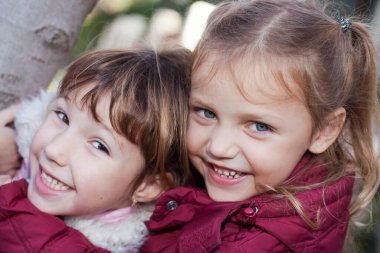 portrait of two cheerful little girls outdoors