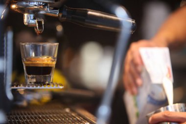 Kafede kahve yapan baristanın ellerine yakın çekim.