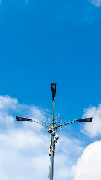 Yogyakarta, Indonesia - January 14, 2023: Low angle portrait of green street lights with Javanese ornaments near Malioboro Street in the kilometer 0 area.