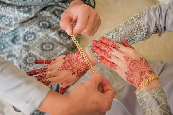 신랑은 말레이시아에서 말레이인들의 결혼식에서 신부의 팔찌를 착용하고 Brides Hand Henna — 스톡 사진