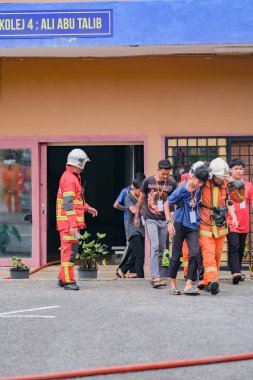 Muadzam Şah, Malezya - 10 Ağustos 2023: İtfaiyeciler 2023 Ajanslar Arası Felaket Eğitim Programı 'nda bir yangın tatbikatında yaralı bir genci kurtardılar
