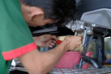 Segamat, Malezya - 3. Şube, 2024: Segamat 'ta bir motosikleti tamir eden tamirci.