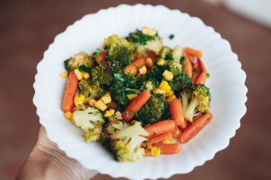 plate of vegetables in hand