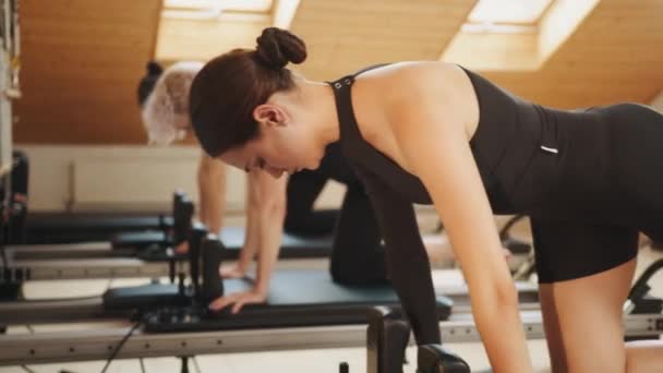 Group Active Woman Making Plank Exercise While Workout Reformer Bed — Video